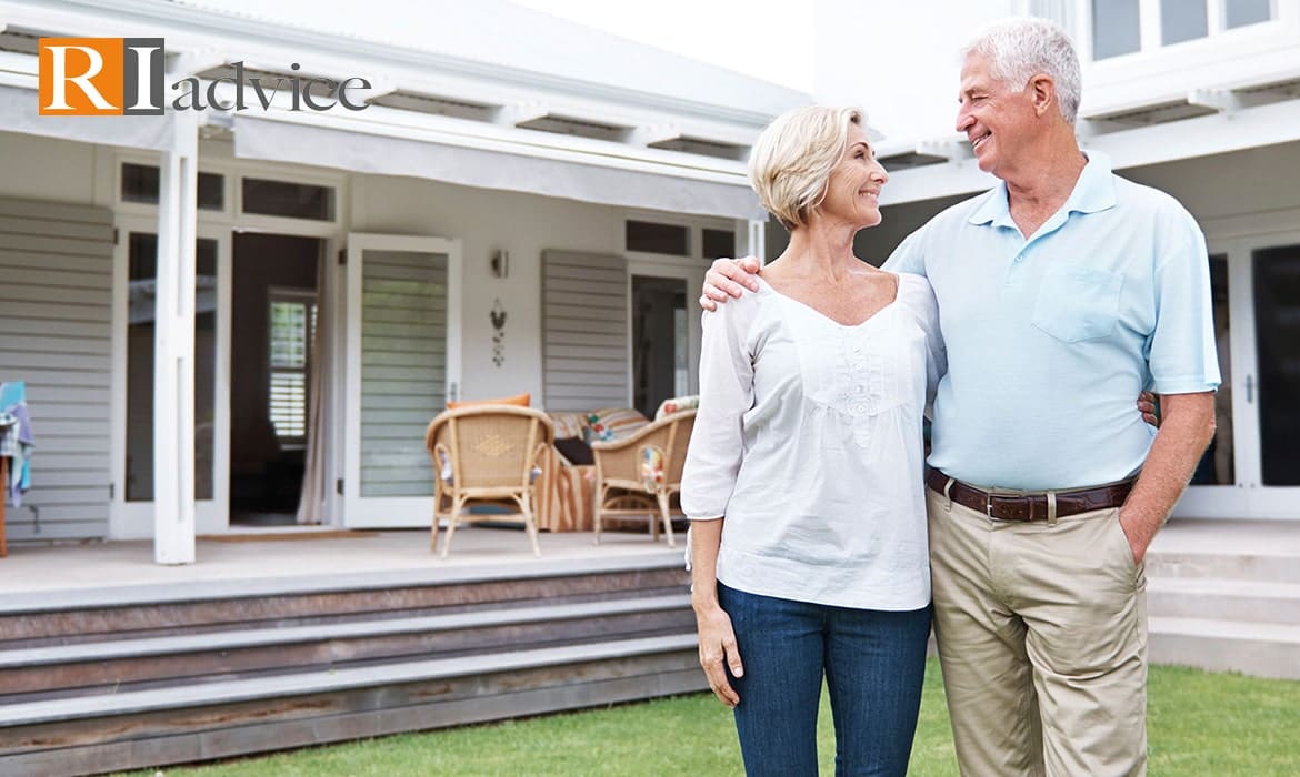 Two seniors happy and smiling in the backyard of their house